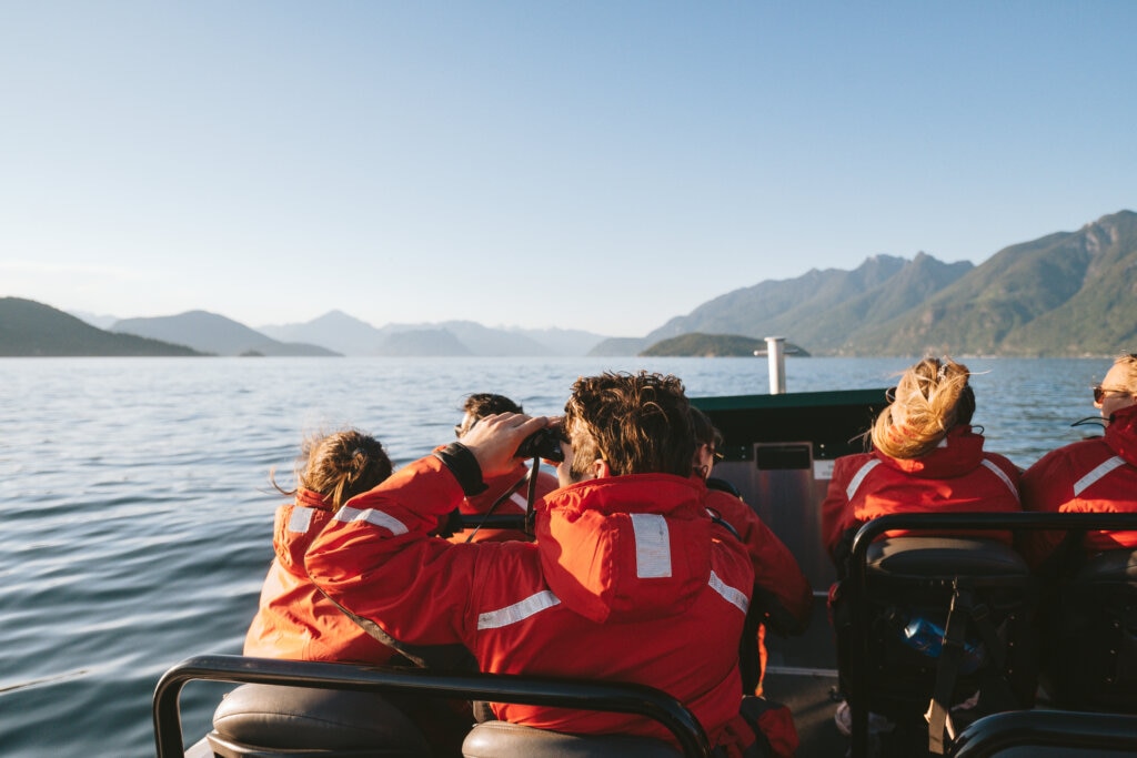 A group of tourists set out on a whale watching adventure with the beautiful Howe Sound they are travelling through